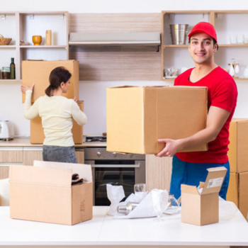 a packing and moving guy happily uplifting the fragile items carefully